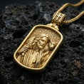 Load image into Gallery viewer, Gold plated Good Shepherd pendant with detailed Jesus portrait, lamb over the shoulders, and engraved geometric background showcased on black volcanic rock in a refined macro jewelry image