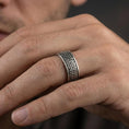 Load image into Gallery viewer, Oxidized Celtic knot band ring worn on a finger, lifestyle wear shot showing antique contrast and the continuous knot pattern at true scale.