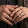 Load image into Gallery viewer, Rose gold plated woven texture band ring worn on a finger, lifestyle photo featuring elegant rosy sheen and detailed woven texture.