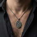 Load image into Gallery viewer, Oxidized Saint Christopher pendant with Child Jesus and staff worn on the neck in a lifestyle jewelry shot, styled against the chest for a devotional and timeless look