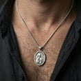 Load image into Gallery viewer, Polished silver Saint Anastasia medallion with orthodox saint relief worn on the neck in a close lifestyle frame, highlighting the oval silhouette and refined sacred detailing