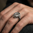 Load image into Gallery viewer, Oxidized sterling silver koi fish wrap ring worn on the finger, lifestyle photo focusing on bold contrast, sculpted koi head, and statement coil silhouette.