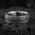 Load image into Gallery viewer, Oxidized sterling silver pebble texture band ring on volcanic stone, macro close-up highlighting hammered stone-like relief and darkened depth.