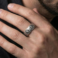 Load image into Gallery viewer, Oxidized sterling silver Greek sculpture ring worn on the finger, lifestyle image highlighting bold museum-inspired character and strong contrast engraving.