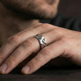 Load image into Gallery viewer, Polished silver faceted geometric band ring worn on the finger, lifestyle shot highlighting sleek minimal style, sharp facets, and everyday wear versatility.