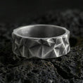 Load image into Gallery viewer, Oxidized sterling silver faceted geometric band ring on volcanic stone, macro close-up highlighting sharp pyramid cuts and deep contrast shadows.