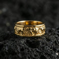 Load image into Gallery viewer, Gold plated horse band ring on volcanic stone, premium macro photo capturing warm golden tone across the carved horse motif and smooth comfort edges.