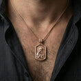 Load image into Gallery viewer, Rose gold plated Madonna and Child pendant with framed devotional relief worn on the neck in a refined lifestyle shot with a warm and elegant presentation