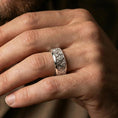 Load image into Gallery viewer, Rotating wave spinner ring worn on a finger, polished silver look with crisp reflections along the rotating band and smooth edges.