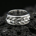 Load image into Gallery viewer, Mechanic style spinning fidget band ring on black volcanic stone, photographed in polished silver with clean reflections across the geometric facets and smooth rounded edges.