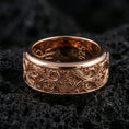 Load image into Gallery viewer, Ornate scrollwork sterling silver band ring on black volcanic stone, shown in a rose gold plated finish with a softer warm tone accenting the ornamental curves.
