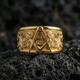 Load image into Gallery viewer, Sterling silver Masonic square and compass band ring on black volcanic stone, presented in a gold plated finish with warm shine that highlights the central emblem and engraved textures.