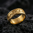 Load image into Gallery viewer, Sterling silver band ring photographed on black volcanic stone, shown in a gold plated finish that enhances the playful three-monkey scene with a warm premium shine.