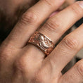 Load image into Gallery viewer, Koi fish spinner band ring worn on a finger, rose gold plated finish with a refined warm tone and smooth comfort-fit profile.