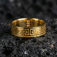 Load image into Gallery viewer, Gold plated Greek key pattern band ring on volcanic rock, classic meander motif with crisp edge detail, luxury jewelry product photography.