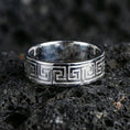 Load image into Gallery viewer, Polished silver Greek key wedding band on black volcanic stone, clean geometric meander border, centered close-up studio lighting.