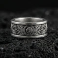 Load image into Gallery viewer, Oxidized sterling silver lion medallion band ring on dark volcanic rock, ornate Gothic arch and quatrefoil engraving, premium macro product shot.