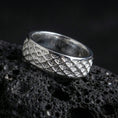 Load image into Gallery viewer, Polished silver lattice pattern band ring on black volcanic stone, crisp diamond grid texture and clean borders, centered close-up studio lighting.