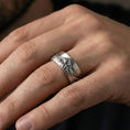 Load image into Gallery viewer, Oxidized sterling silver mountain landscape band worn on finger, raised peak relief detail, natural lifestyle hand shot with shallow depth of field.