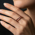 Load image into Gallery viewer, Rose gold plated octopus tentacle ring worn on finger, sculpted suction cup pattern with elegant wrap design, lifestyle wear shot.