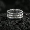 Load image into Gallery viewer, Polished silver snake scale texture band ring on black volcanic stone, crisp reptile pattern engraving and clean borders, centered close-up studio lighting.