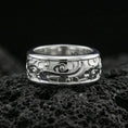 Load image into Gallery viewer, Polished silver fidget spinner cloud and flower band ring on black volcanic stone, crisp cartoon-style swirl relief with smooth comfort edges, centered close-up studio lighting.