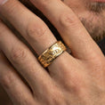 Load image into Gallery viewer, Gold plated spinning lion wedding band worn on finger, detailed lion engraving on rotating band, premium lifestyle jewelry photo.