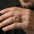 Load image into Gallery viewer, Rose gold plated steampunk skull ring worn on finger, sculpted skull relief with mechanical tubing detail, elegant lifestyle wear shot.