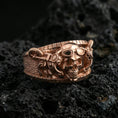 Load image into Gallery viewer, Rose gold plated sterling silver steampunk skull ring on volcanic stone, sculpted skull relief with mechanical tubing and deep contrast, minimal high-end close-up.