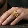 Load image into Gallery viewer, Gold plated biker skull ring worn on finger, detailed helmet and goggles with rugged skull relief, premium lifestyle jewelry photo.