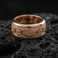 Load image into Gallery viewer, Rose gold plated sterling silver ornament band on volcanic stone, intricate filigree and floral panel engraving with deep contrast, minimal high-end close-up.