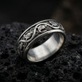 Load image into Gallery viewer, Oxidized sterling silver dove pattern band ring on dark volcanic rock, repeating bird motif with elegant scrollwork, premium macro product shot.