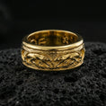 Load image into Gallery viewer, Gold plated jaguar spinner band ring on volcanic rock, detailed big cat engraving on rotating center with rugged texture, luxury jewelry product photography.