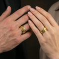 Load image into Gallery viewer, Gold plated octopus spinner band worn on finger, detailed octopus motif on rotating band, premium lifestyle jewelry photo.