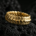 Load image into Gallery viewer, Gold plated dragon scale texture band ring on volcanic rock, detailed segmented ridge pattern with bold depth, luxury jewelry product photography.