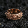 Load image into Gallery viewer, Rose gold plated sterling silver lotus spinner ring on volcanic stone, sculpted lotus blossoms with deep contrast and clean borders, minimal high-end close-up.