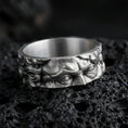 Load image into Gallery viewer, Oxidized sterling silver Michelangelo Moses spinner band ring on dark volcanic rock, Renaissance portrait relief on rotating center, premium macro product shot.
