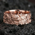 Load image into Gallery viewer, Rose gold plated sterling silver oni mask ring on volcanic stone, sculpted demon face relief with deep contrast and ornate side motifs, minimal high-end close-up.