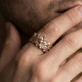 Load image into Gallery viewer, Rose gold plated oni mask ring worn on finger, sculpted demon face relief with ornate side motifs, elegant lifestyle wear shot.