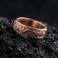 Load image into Gallery viewer, Rose gold plated sterling silver tree branch band on volcanic stone, sculpted root and leaf relief with deep contrast, minimal high-end close-up.