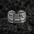 Load image into Gallery viewer, Polished silver Last Supper religious band ring on black volcanic stone, crisp engraved apostle scene relief with smooth comfort edges, centered close-up studio lighting.