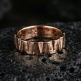Load image into Gallery viewer, Rose gold plated geometric cut band ring on volcanic stone, sculpted wedge facets with rich dimensional contrast, premium close-up product photo.