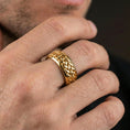 Load image into Gallery viewer, Gold plated Celtic knot woven band ring worn on finger, raised braid pattern with rich highlights, premium lifestyle jewelry photo.