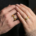 Load image into Gallery viewer, Gold plated rugged hammered band worn on finger, bold metallic glow across the molten texture, lifestyle jewelry photo.