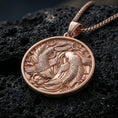Load image into Gallery viewer, Rose gold plated yin yang fish necklace with two sculpted koi, flowing botanical elements, and circular symbolic design resting on volcanic rock in an elegant close-up product presentation