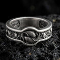 Load image into Gallery viewer, Oxidized sterling silver Yin Yang koi fish band ring on black volcanic stone, darkened relief emphasizing the twin koi and lotus side details, macro product photo.