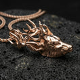 Load image into Gallery viewer, Rose gold plated deer pendant with detailed stag profile, sculpted antlers, and elegant forest animal form resting on volcanic rock in an elegant close-up product presentation