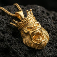 Load image into Gallery viewer, Gold plated gorilla king pendant with regal crown detail, roaring ape relief, and powerful statement silhouette showcased on black volcanic rock in a refined macro jewelry image