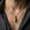 Load image into Gallery viewer, Gold plated alligator skull pendant with detailed reptilian form and open-mouth jaw design worn on the neck in a premium lifestyle composition with strong animal-inspired jewelry styling
