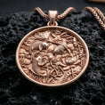 Load image into Gallery viewer, Rose gold plated lotus pond necklace with sculpted koi fish design, floral water garden details, and graceful circular silhouette resting on volcanic rock in an elegant close-up product presentation